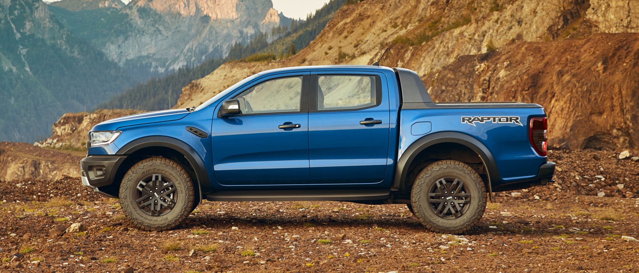 Ranger Raptor parked with mountains backdrop