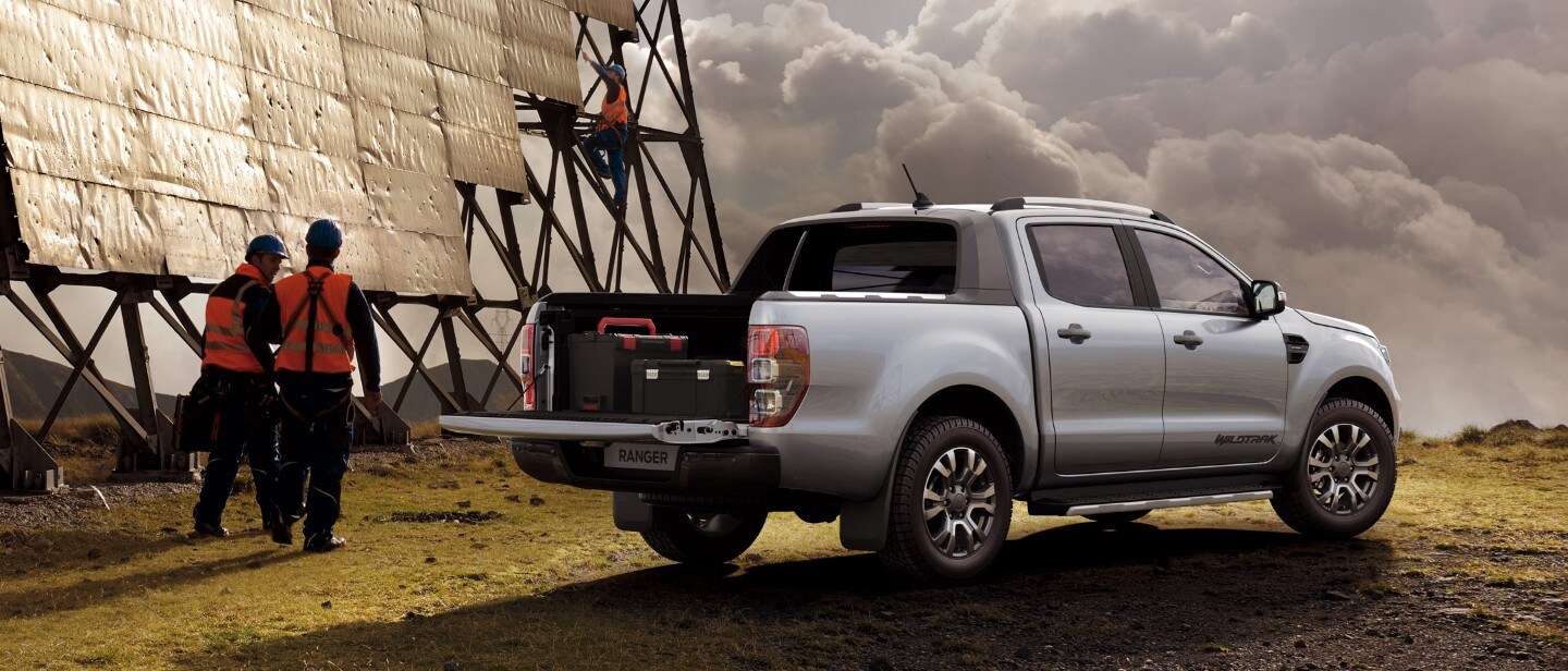 Silver Ford Ranger Wildtrak truck bed open parked near solar panels Silver Ford Ranger Wildtrak truck bed open parked near solar panels