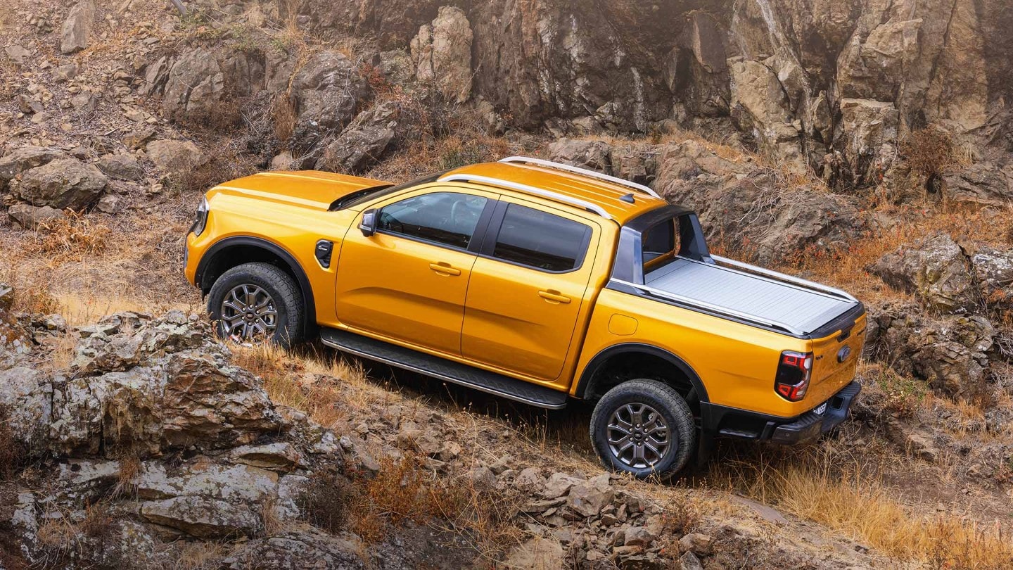 Orange Ford Ranger driving uphill