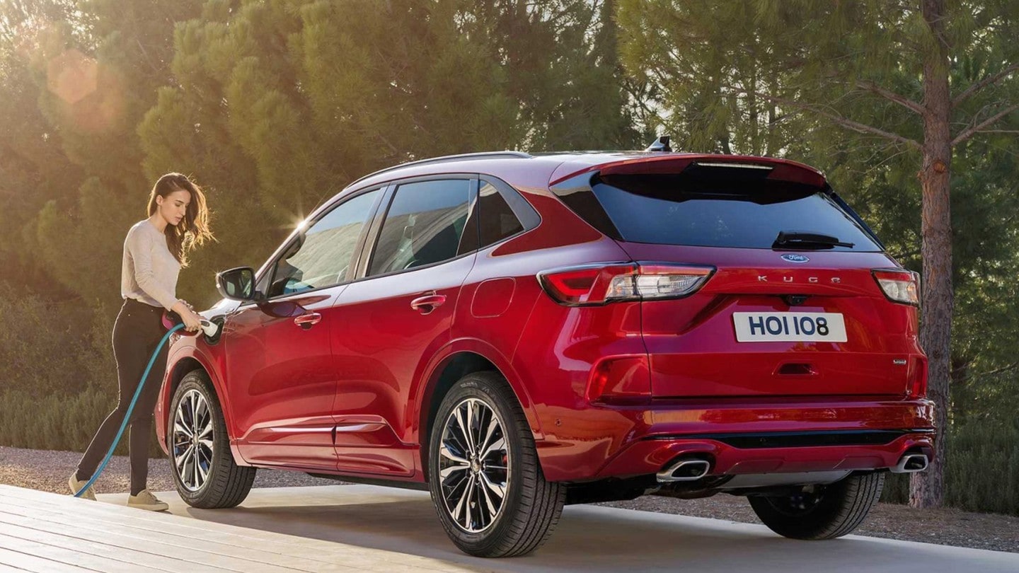 A woman charging red Ford Kuga