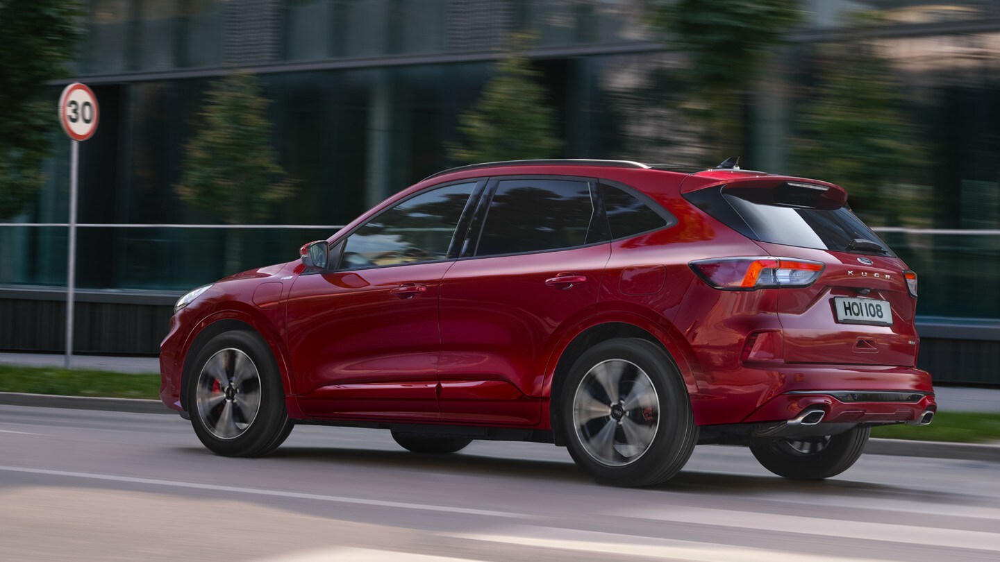 All new Ford Kuga driving on road with road sign