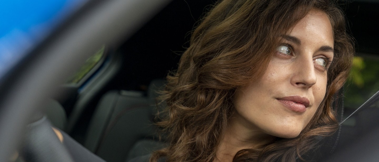 Woman looking out of a driver's window