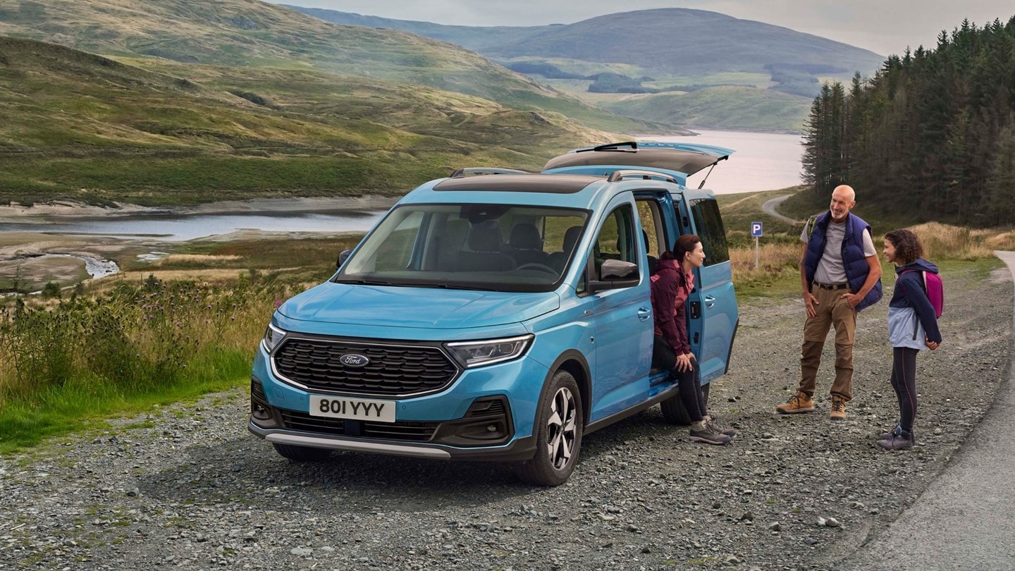 A family standing by a parked Tourneo Connect