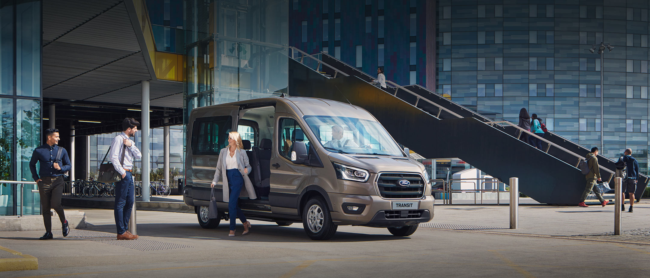 All New Ford Transit Minibus parked outside glass building All New Ford Transit Minibus parked outside glass building