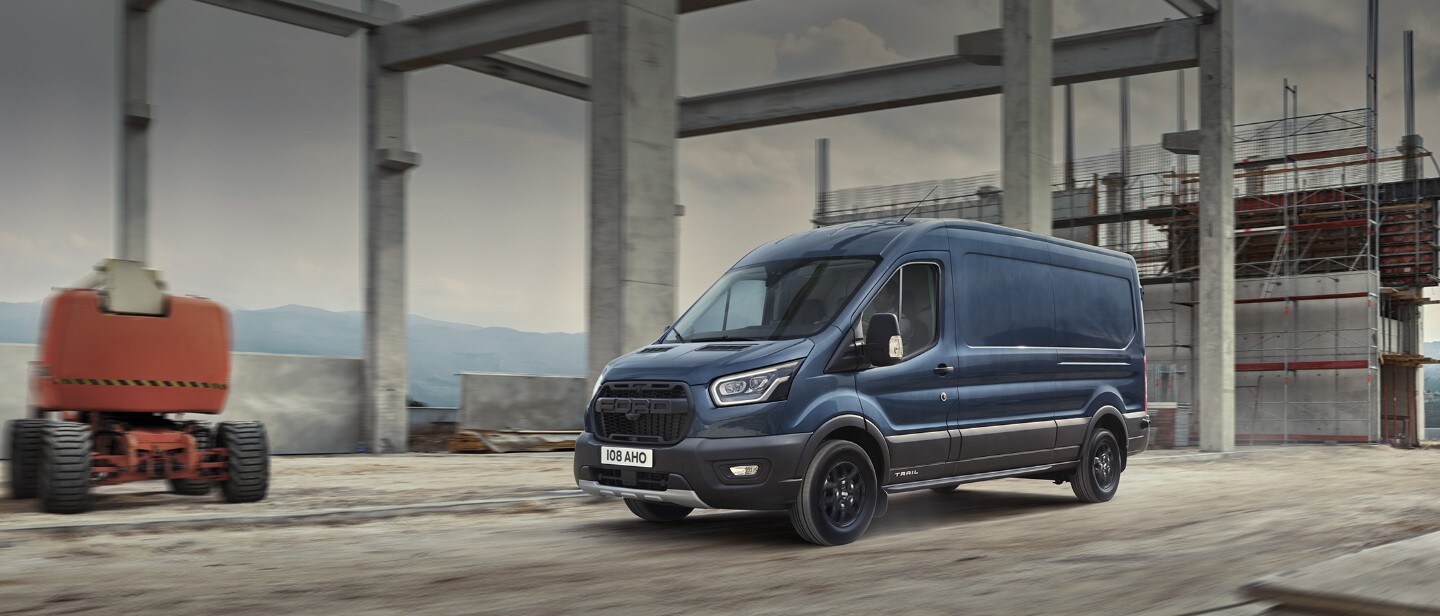 Transit Van in motion driving through industrial estate