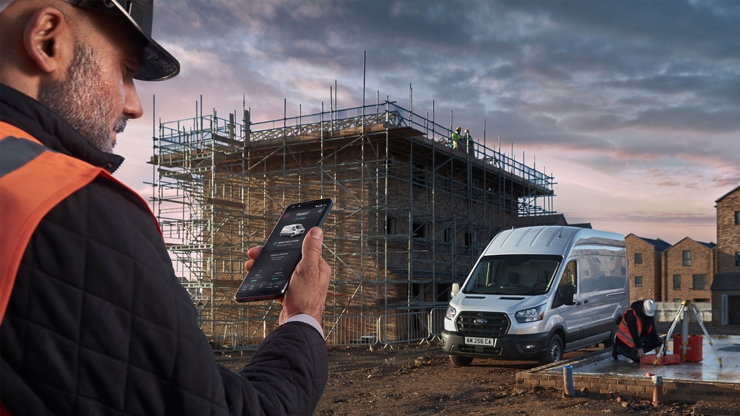 Building site with Ford Transit and person checking his mobile