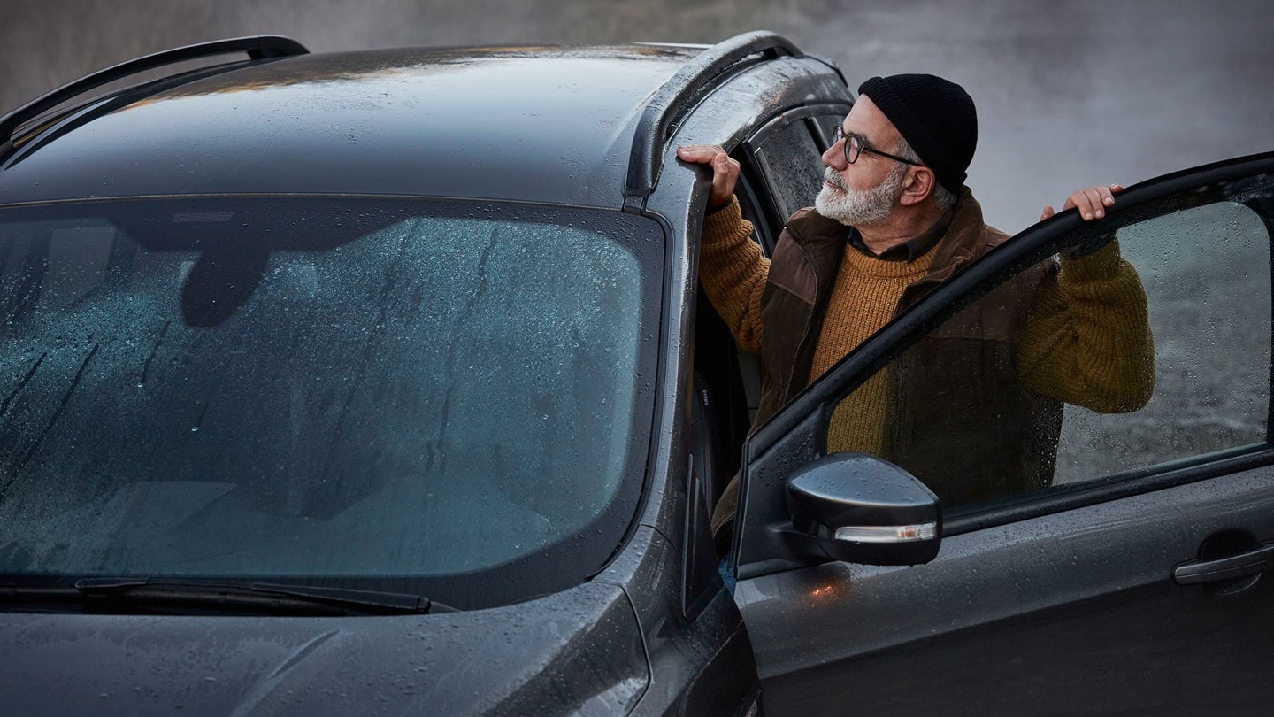 Old man checking roof