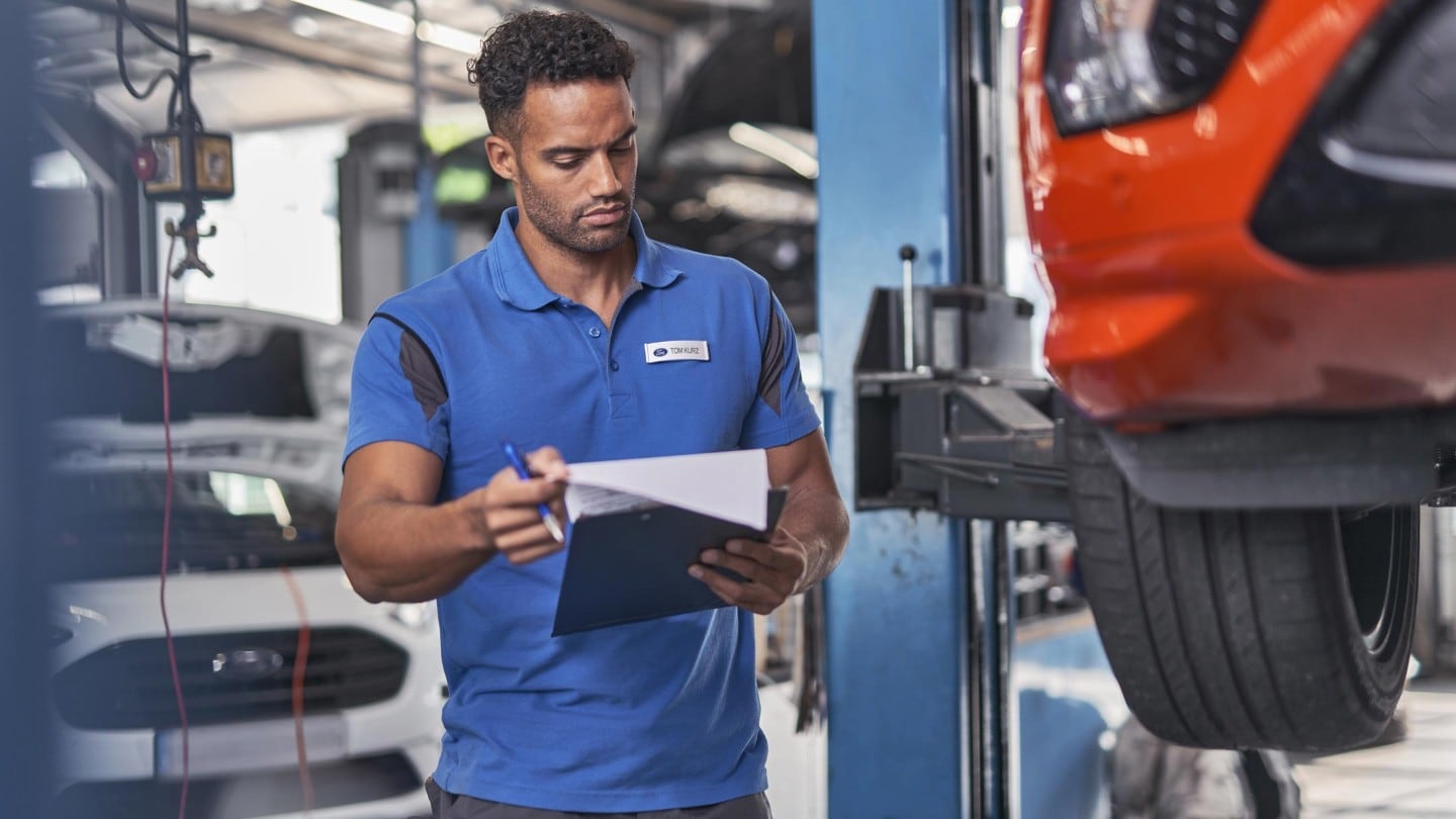 Ford Service engineer, inspecting wheels